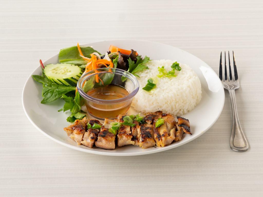 C2. Lemongrass Chicken Rice · Marinated chicken thigh served with steamed rice, vegetables and a side of fish sauce.