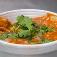 Tadka Dal · Yellow lentils cooked with onions and tomatoes and garnished with cilantro. Served with rice.