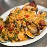 Paella Valenciana · Rice mixed with chicken, sausage and seafood.