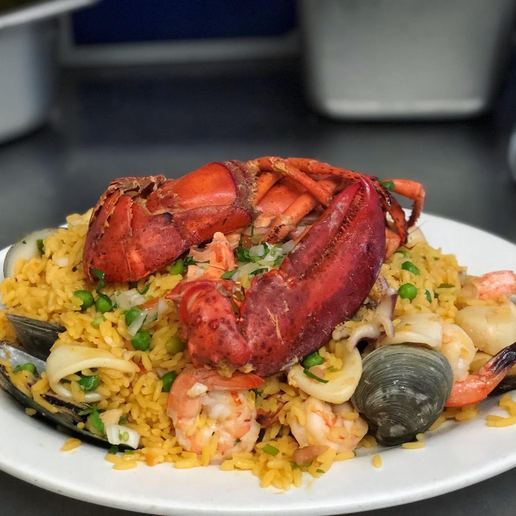 Paella Marinara · Rice mixed with seafood and half lobster.