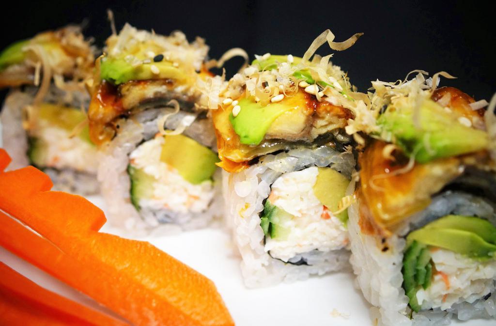 Dragon Roll · 8 pieces. Crab, cucumber, avocado topped with baked eel, avocado, dry fish flakes, and sweet eel sauce.