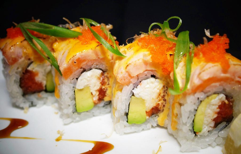 Volcano Roll · 8 pieces. Spicy tuna, crab, avocado topped with salmon, green onion, dry fish flakes, fresh roe, and sweet eel. Spicy.