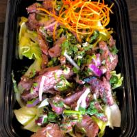 Waterfall Beef Salad · Grilled marinated beef tossed with red onion, scallion, fresh mint, chili powder, lime juice...
