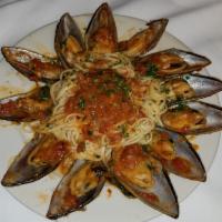 Linguine Pescatore · Mussels, clams, fish, shrimp, and calamari with tomato sauce.