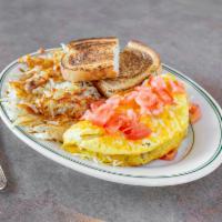 Kopper Omelet · A fluffy, three-egg omelet stuffed with bacon, ham and sauteed mushrooms and topped with che...