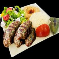 Beef Kofta Kebabs · 2 beef kofta kebabs, traditional hummus, rice, greek salad and a pita bread topped with gril...