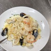 Seafood Combo · Shrimp, clams, mussels, scallops, and calamari over linguine pasta in pinot noir marinara sa...