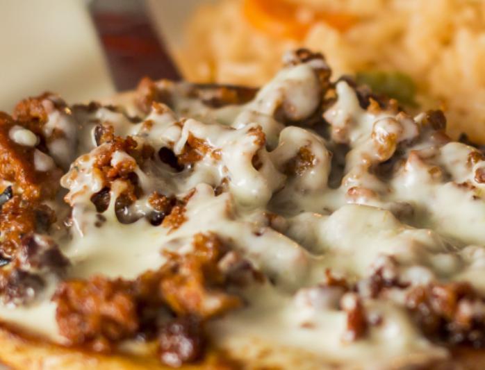 Chori Pollo · Grilled marinated chicken and chorizo Mexican sausage topped with cheese sauce. Served with rice and 3 tortillas.