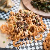 Brisket Curly Fries · Mesquite smoked brisket and cheddar jack cheese-loaded curly fries. Topped with our house sa...