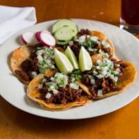 Tacos · Corn tortillas with choice of meat garnished with cilantro and onion.