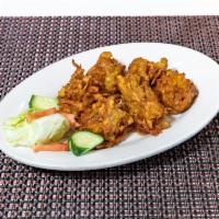 9. Onion Bhaji · Deep fried onion with lentils and battered herbs.