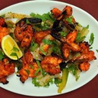 60. Tandoori King Prawn · Jumbo size king prawns marinated in a light spicy sauce and homemade  yogurt and skewed then...