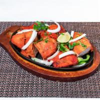 65. Tandoori Chicken · Marinated in spicy tandoori sauce with herbs, ginger, garlic and homemade yogurt, grilled in...