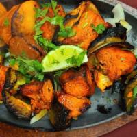 68. Chicken Shashlik · Marinated chicken tikka mixed with herbs and spices and grilled in a tandoori clay oven.