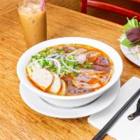 Bun Bo Hue · Spicy beef soup. Rice noodles, beef shank, beef tendons, pork shank, pork knuckles, blood cu...
