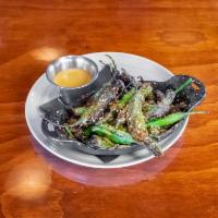 Shishito Peppers  · Blistered peppers, red pepper flakes, sesame seeds, and umami sauce.