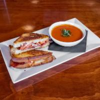 Grilled Cheese  · White cheddar cheese, bacon, heirloom tomatoes, sourdough, and tomato soup with fresh basil.