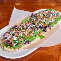 Smoked Salmon Flatbread Brunch · Smoked salmon, baby greens, red onion, capers, and citrus crema.