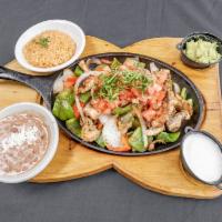 Chicken Fajitas · Sizzled in a succulent white wine marinade with onions, peppers and tomatoes. Served with to...