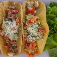 Taco Sampler · Carnitas, carne asada and chicken topped with guacamole, pico de gallo, Cotija cheese and sa...