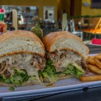 Torta Oaxaquena · Milanese, carnitas, Jack cheese, lettuce, tomatoes, onions, avocado and chipotle mayo.