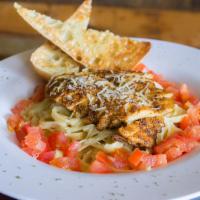 Blackened Chicken Alfredo · Fettuccine pasta tossed in Alfredo sauce with Parmesan cheese and tomatoes topped with black...