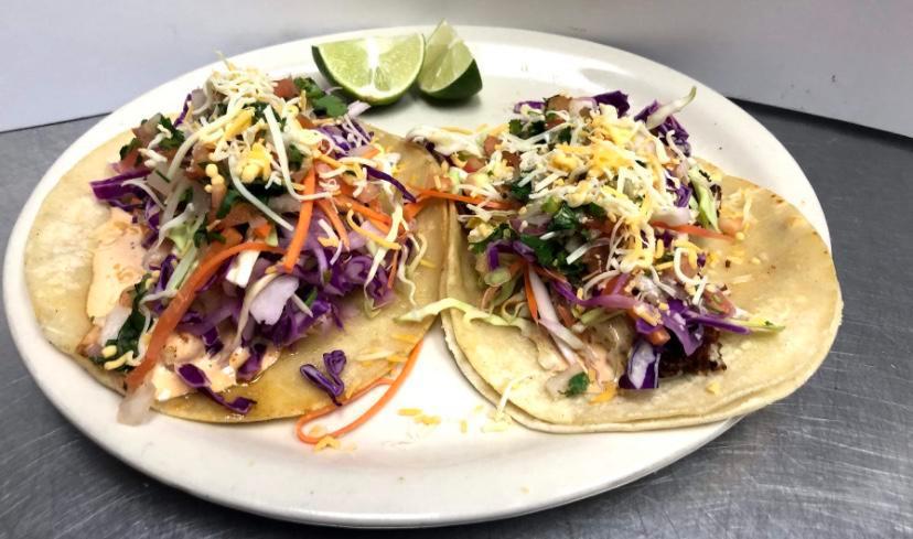 Fish taco  ·  a double corn tortilla taco  with cabbage, cheese , pico de Gallo and chipotle and your choice of grill or fried fish 