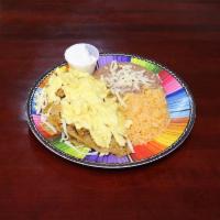 Chilaquiles · Fried tortilla chips covered in your choice of sauce topped with scra,bled eggs, sour cream,...