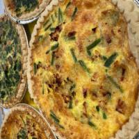 Quiche of The Day with Side Salad or Cup of Soup  · Quiche of the day with side garden salad or cup of soup.  
QUICHE: Artichoke Spinach