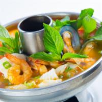 13. Tom Yum Seafood Soup · Lemongrass, basil, ginger, kaffir lime leaves galangal and cilantro in hot and sour soup.