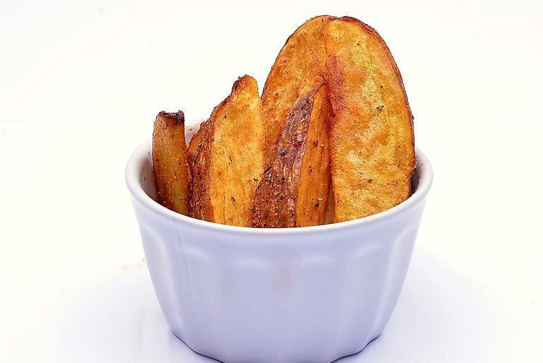 Potato Wedges and Dipping Sauce · House-cut potato wedges with herb seasoning.