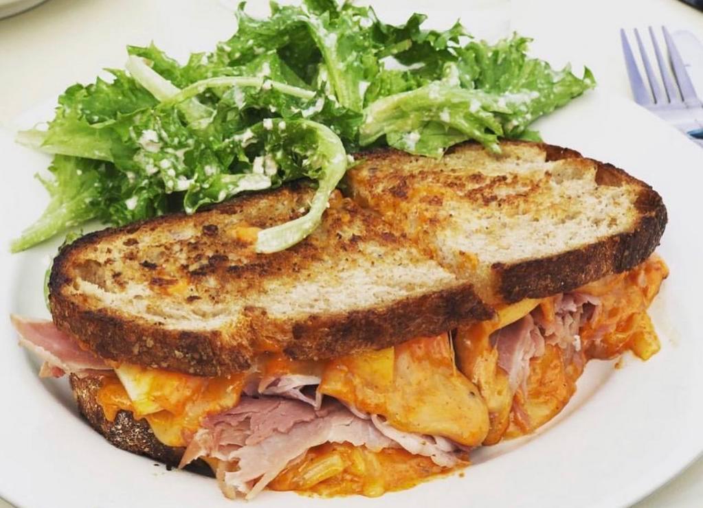 Apple and Ham Grilled Cheese Sandwich · Sourdough bread grilled cheese with country ham, sliced apples, and spicy pimento cheese.
