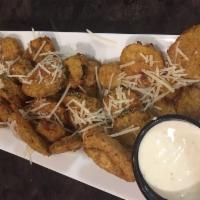 Valley Fried Pickles · Batter-dipped pickle chips sprinkled with Parmesan cheese and served with FiresSide's homema...