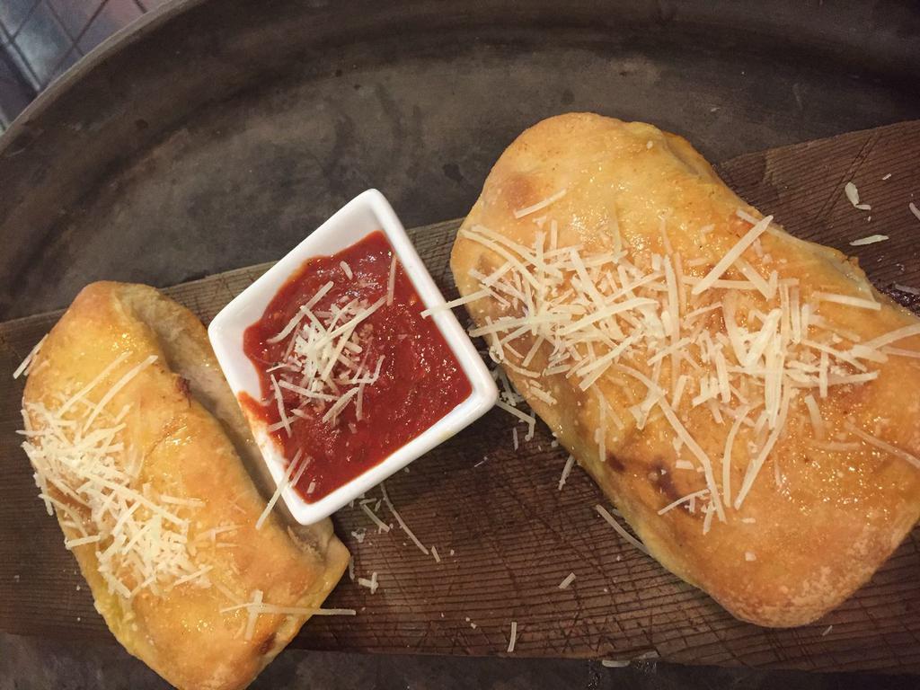 Putnam Pepperoni Rolls(2) · Pepperoni, ricotta and mozzarella cheese, a pinch of garlic salt, wrapped up and topped off with a little melted butter and Parmesan cheese. Served with a side of marinara.