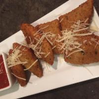 Fried Mozzarella Triangles · Topped with aged Parmesan cheese and served with a hearty marinara sauce.