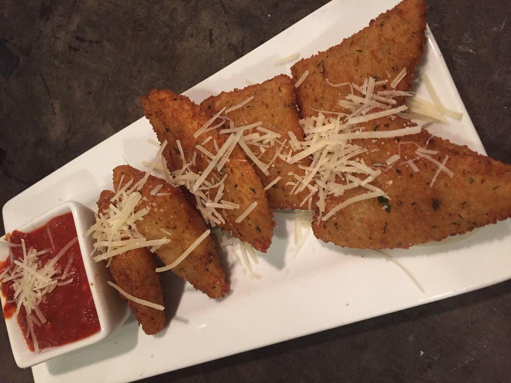 Fried Mozzarella Triangles · Topped with aged Parmesan cheese and served with a hearty marinara sauce.