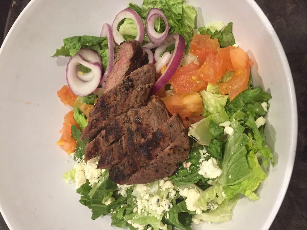 Black and Bleu Salad · Our classic Caesar topped with our house sirloin steak, bleu cheese crumbles, tomatoes and red onion.