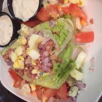 West Virginia Wedge Salad · Iceberg lettuce wedge with bacon, egg, diced red onions, tomatoes and bleu cheese crumbles.