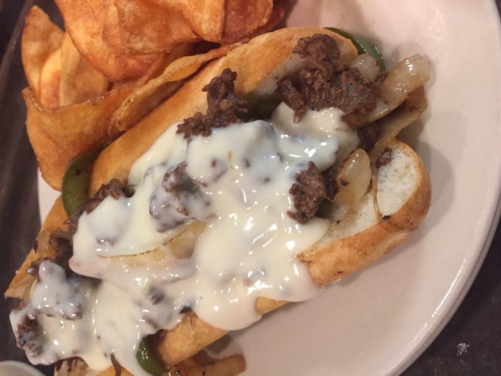 Philly Cheese Sandwich · Shaved Ribeye or Grilled Chicken topped with grilled peppers and onions. Steak Philly is served with our white queso cheese sauce and our chicken Philly is served with provolone cheese. Served with FireSide thick-sliced potato chips.