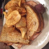 River City Smoked Turkey Sandwich · A lightly smoked turkey sliced thin and accompanied with smoked bacon, Muenster cheese and h...