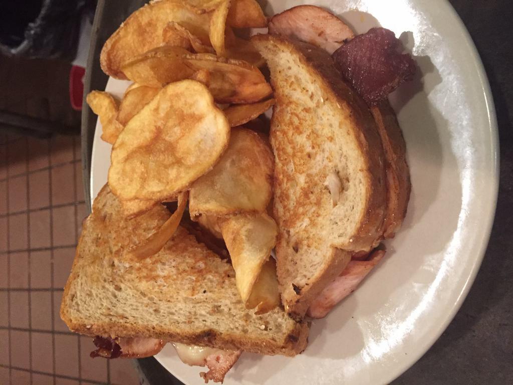 River City Smoked Turkey Sandwich · A lightly smoked turkey sliced thin and accompanied with smoked bacon, Muenster cheese and honey mustard on our wheatberry bread . Served with Fireside thick-sliced potato chips.