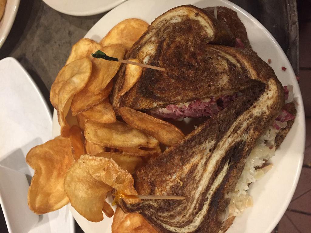 Best Reuben Ever Sandwich · Hand-shaved corned beef brisket topped with seasoned sauerkraut, Swiss cheese and Thousand Island dressing on Jewish rye. Served with FireSide thick-sliced potato chips.