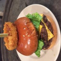 Big John Burger · Our double cheeseburger topped with a homemade onion ring, deep fried pickles, lettuce, toma...