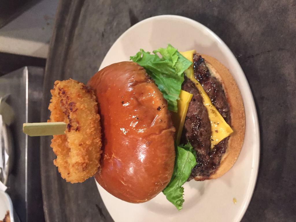 Big John Burger · Our double cheeseburger topped with a homemade onion ring, deep fried pickles, lettuce, tomato and onion. Served with FireSide thick-sliced potato chips.