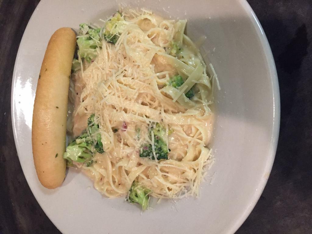 Classic Fettuccine Alfredo Pasta · Creamy Alfredo sauce with Parmesan cheese and hints of garlic and onions smothering fettuccine noodles and broccoli. Served with a house salad.