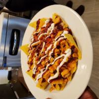 Nachos Lunch · Gluten free chips, Mattie's cashew queso, pinto beans, pico, cashew sour cream, and your cho...