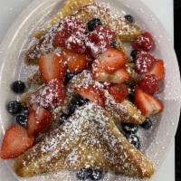Fresh Berry French Toast · French toast topped with fresh strawberries, blueberries, and raspberries. Dusted with powde...
