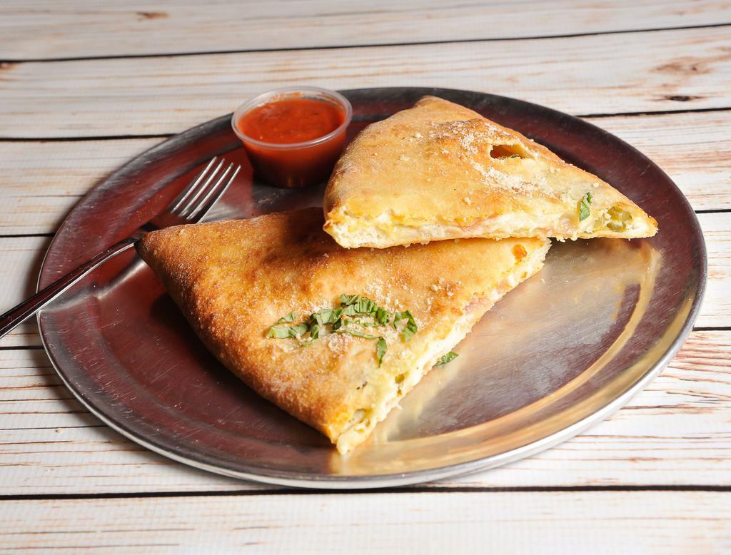 Spicy Pig Calzone · House made dough stuffed with 100% whole milk mozzarella cheese, fresh ricotta, sliced jalapenos and bacon.