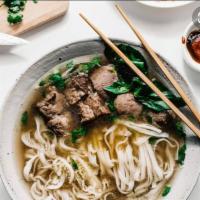 Beef Noodle Soup · Pho. Vietnamese aromatic beef soup and Pho noodles topped with white and green onions, Thai ...