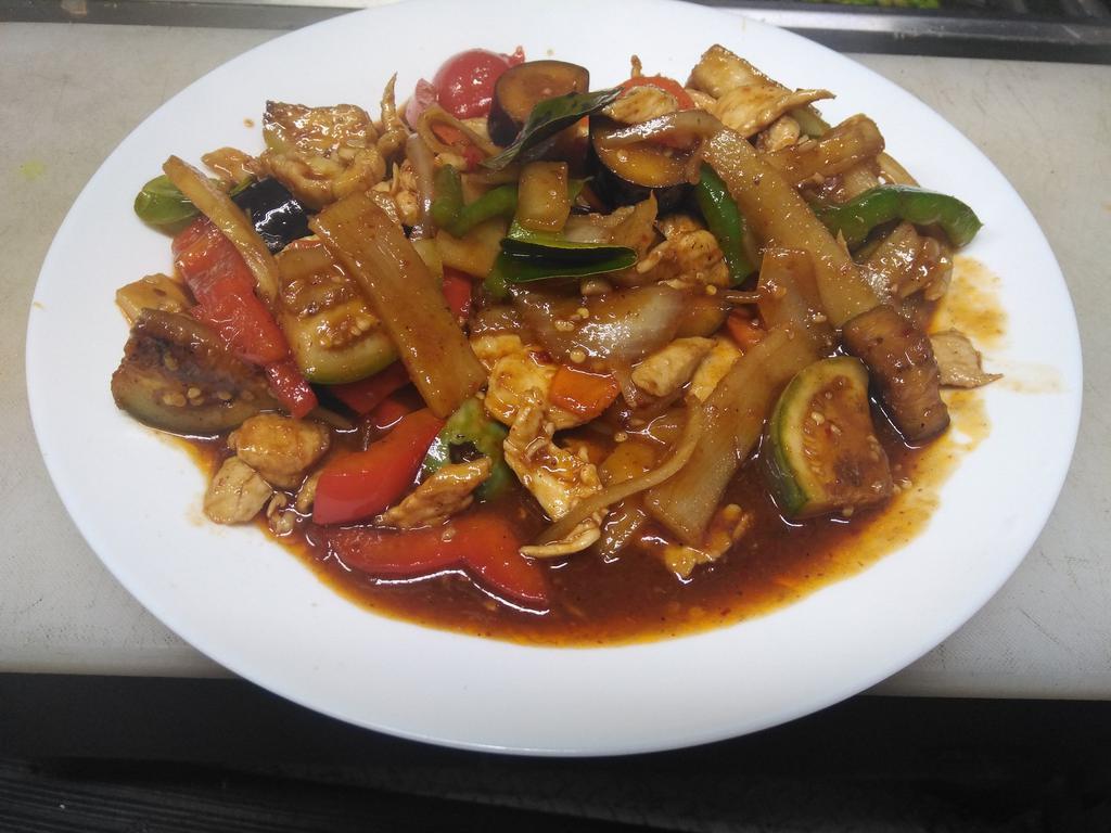 37. Pad Phet · Stir fried Thai eggplant, bamboo shoots, onions, bell pepper, basil and kaffir leaves cooked with Thai curry paste.